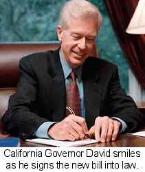 California Governor David smiles as he signs the new bill into law.